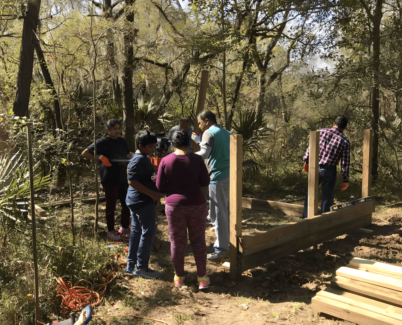 People building a wooden structure outdoors