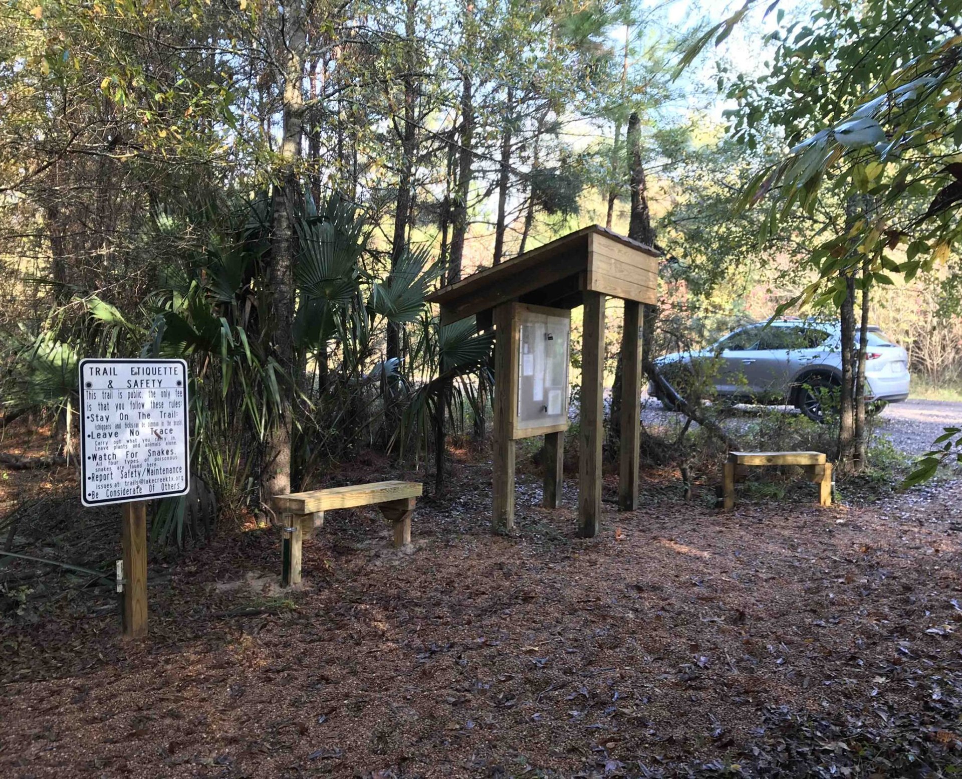 Car parked near forest trail entrance